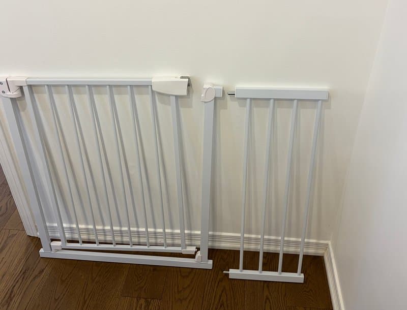 Original phone photo of a white metal pet gate